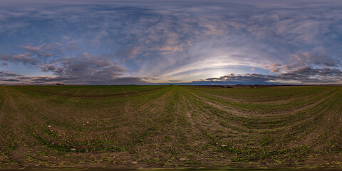 Wall Mural - spherical 360 hdri panorama among farming field with clouds on evening blue sky after sunset in equi