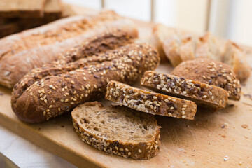 Wall Mural - fresh loaf of bread on wooden board