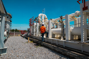 Wall Mural - Male worker inspection at steel long pipes and pipe elbow in station oil factory during refinery valve of visual check record pipeline oil