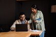 © Drobot Dean - Smiling businesspeople using laptop while working together in office