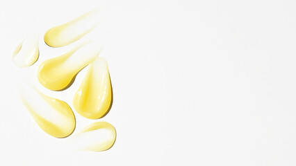 Wall Mural - Smears of yellow cream, balm, conditioner with banana, egg or chamomile on a light background. there is an empty space.