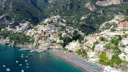 Wall Mural - Aerial view of Positano with comfortable beach and blue sea on Amalfi Coast in Campania, Italy. Positano village on the Amalfi Coast, Salerno, Campania. Beautiful Positano, Amalfi Coast in Campania.