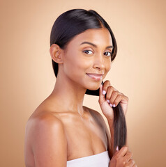 Poster - Portrait, hair care and Indian woman, with beauty, cosmetics and dermatology against a brown studio background. Face, female person or model with luxury, shine and glow with volume, growth or texture