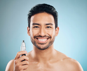 Sticker - Hair removal, face and man with beauty and trimmer, smile and cosmetic care isolated on blue background. Happy male model, tools and shaving, grooming and hygiene with body maintenance in studio