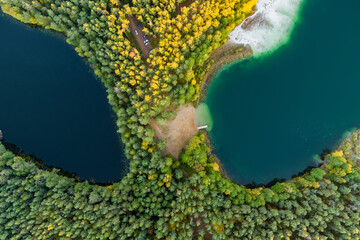 Aerial view of beautiful green waters of lake Gela. Birds eye view of scenic emerald lake surrounded by pine forests. Clouds reflecting in Gela lake, near Vilnius, Lithuania.