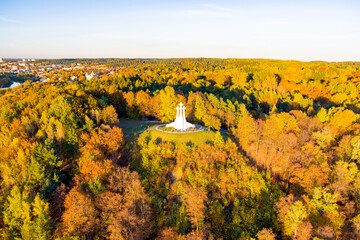 Wall Mural - Aerial view of the Three Crosses monument overlooking Vilnius Old Town on sunset. Vilnius landscape from the Hill of Three Crosses, Vilnius, Lithuania