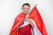 Happy smiling Indonesian man holding Indonesia's flag to celebrate Indonesia Independence Day isolated over white background.