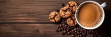 Top View. Close Up Of Hot Chocolate In Cup, Coffee Beans And Freshly Baked Cookies On Brown Wooden Table For Breakfast