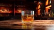 © paulcannoby - glass of whiskey with ice on a wooden table against tbackdrop bar pub background, aglass of expensive whiskey copy space