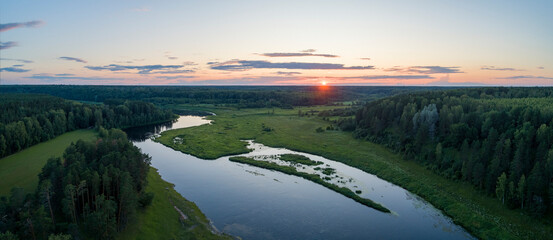 Aufkleber - Aerial panoramic landscape with sunset over the river with islands and beautiful clouds on the sky.
