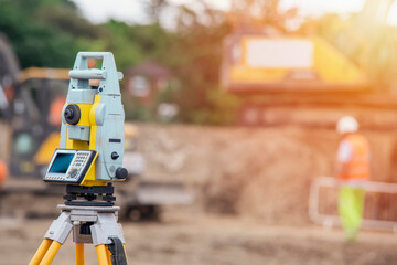 Surveyor equipment EDM tacheometer theodolite set on the tripod outdoors at construction site