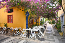 Restaurant And Houses In The Narrow Streets Of Nafplion Town With Bougainvillea Flowers