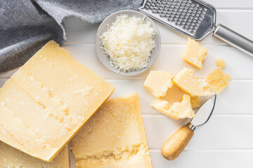 Wall Mural - Tasty parmesan cheese on white table.