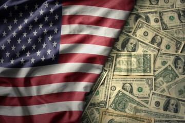 colorful waving national flag of united states of america on a american dollar money background. finance concept