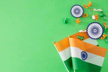 india independence day concept. top view arrangement of indian flags, paper ashoka wheels, sequins o