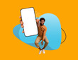 © Prostock-studio - Mobile Ad. Cheerful Black Man Demonstrating Big Smartphone With Blank Screen