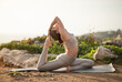 © Prostock-studio - Serious young european woman in sportswear practices yoga, enjoys training and breathing exercises, stretching