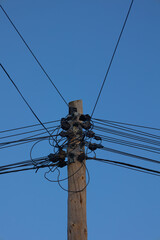 power pole with tangled telephone connection cables