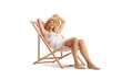 © Ljupco Smokovski - Beautiful young woman in a white dress and straw hat sitting on a beach chair