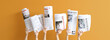 © Pixel-Shot - Female hands with newspapers on orange background