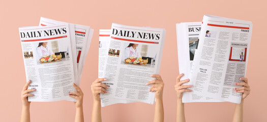 Poster - Female hands with newspapers on pink background