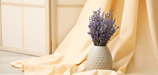 Vase with beautiful lavender flowers in room