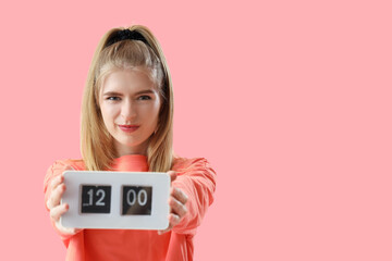 Wall Mural - Stressed young woman with clock on pink background. Deadline concept