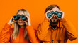 Leinwandbild Motiv  a man and a woman carefully look through binoculars on a orange background.generative AI.