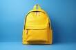 © Deivison - Yellow school bag on blue background, education and creativity concept. Generative AI
