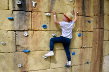 The Boy Is Engaged In Rock Climbing.
