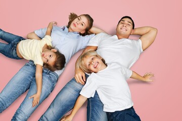 Wall Mural - Young parents with child posing together on background