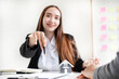 © Orathai - A real estate agent with a home model is talking to clients about renting a house and buying home insurance and contracting the contract after the formal negotiation is completed