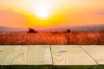 Wall Mural - Wooden table on blur field background