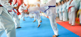 People in martial arts training exercising taekwondo with blur motion