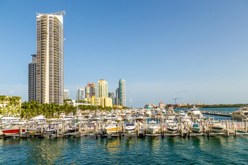 Wall Mural - Miami skyline at daytime with blue sky and view to pier with motor boats