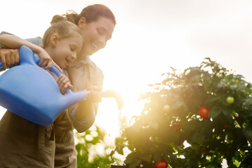 mother and daughter gardening in the backyard