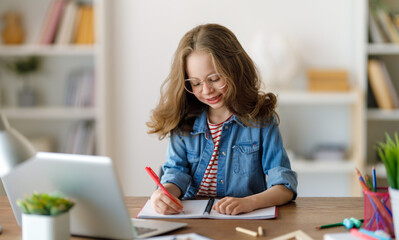 Wall Mural - Girl doing homework or online education.