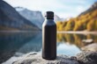 © Medard - Black reusable thermo water bottle with a lake in the background, outdoor concept