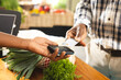 © Wavebreak Media - Senior african american man paying with credit card at health food organic grocery shop