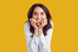 © Studio Romantic - Funny curious woman is excitedly biting her nails in anticipation of something she wants. Close up of Caucasian woman with crazy facial expression on yellow background. People and joy concept.