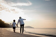 © Garun Studios - Holiday Family on the beach in summer, Travel, vacation and lifestyle concepts. Happy family holidays. Joyful father, baby son walk with fun along edge of sunset sea surf on and beach.