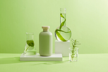 Wall Mural - A green bottle unlabeled on white podiums with laboratory flask containing rosemary leaves, gotu kola and seaweed on green background. Mockup scene for advertising. Concept for organic cosmetic