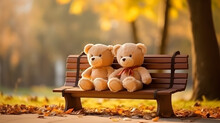 Two Teddy Bear Toys Sitting On Bench At Sunset.