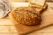 Close up Whole wheat bread with sesame seeds on wooden cutting board.