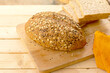 Whole wheat bread with sesame and sunflower seeds on wooden board