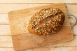Whole wheat bread with sesame seeds on a wooden cutting board