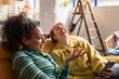 © ReeldealHD images - Two young adult friends laughing together in a shared loft apartment