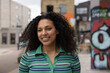 © ReeldealHD images - Portrait of pretty young adult female student on city street