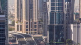 Fototapeta Nowy Jork - Top aerial view of busy road intersection and traffic junctions in Dubai city timelapse.