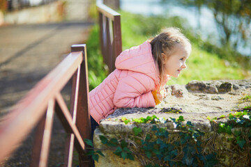 Wall Mural - Adorable preschooler girl enjoying nice autumn day in Saumur, Maine-et-Loire department, Western France